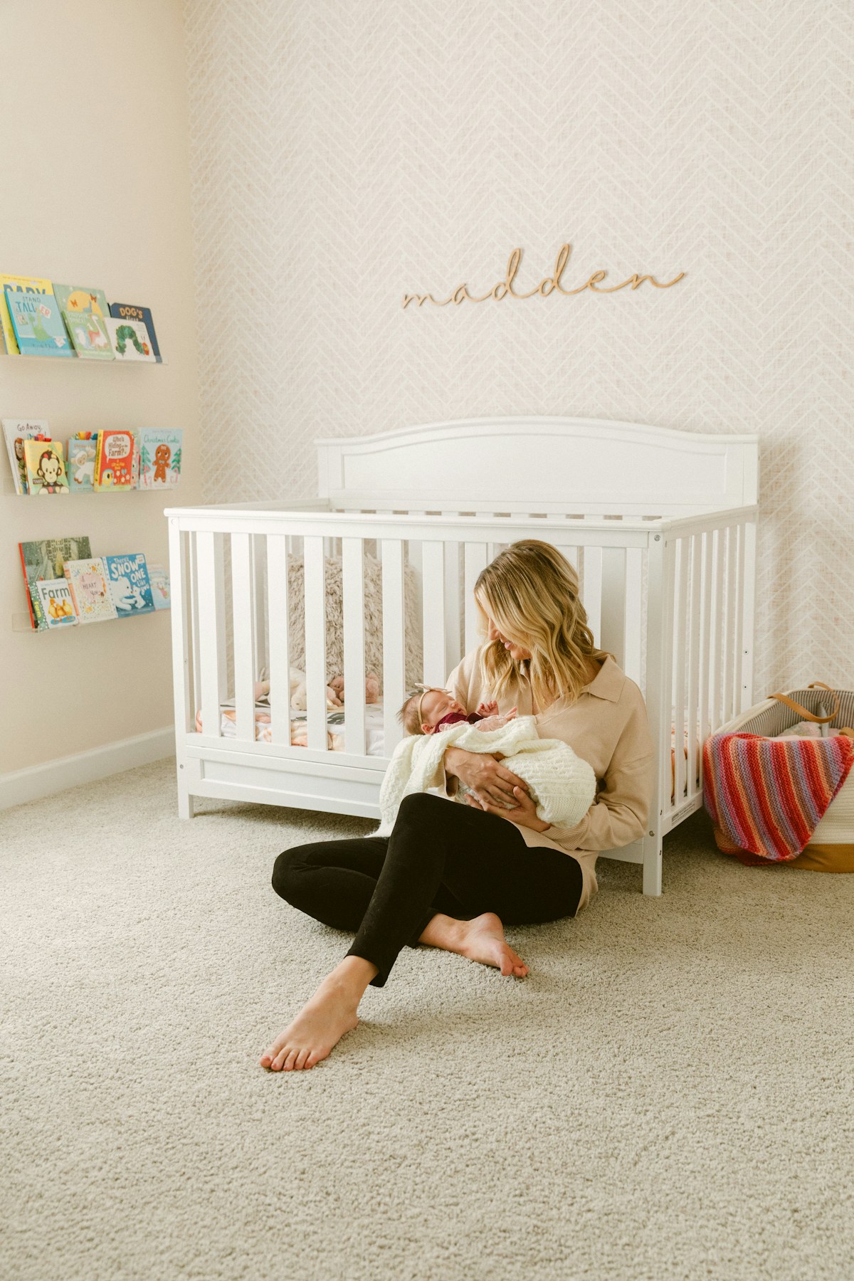 Mother holding her baby in a bright nursery